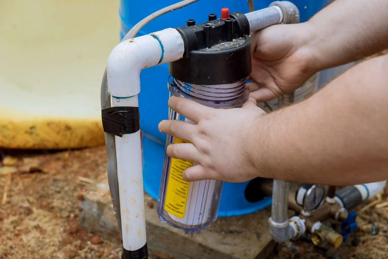 Whole house water filter cartridge being installed on the main water line system